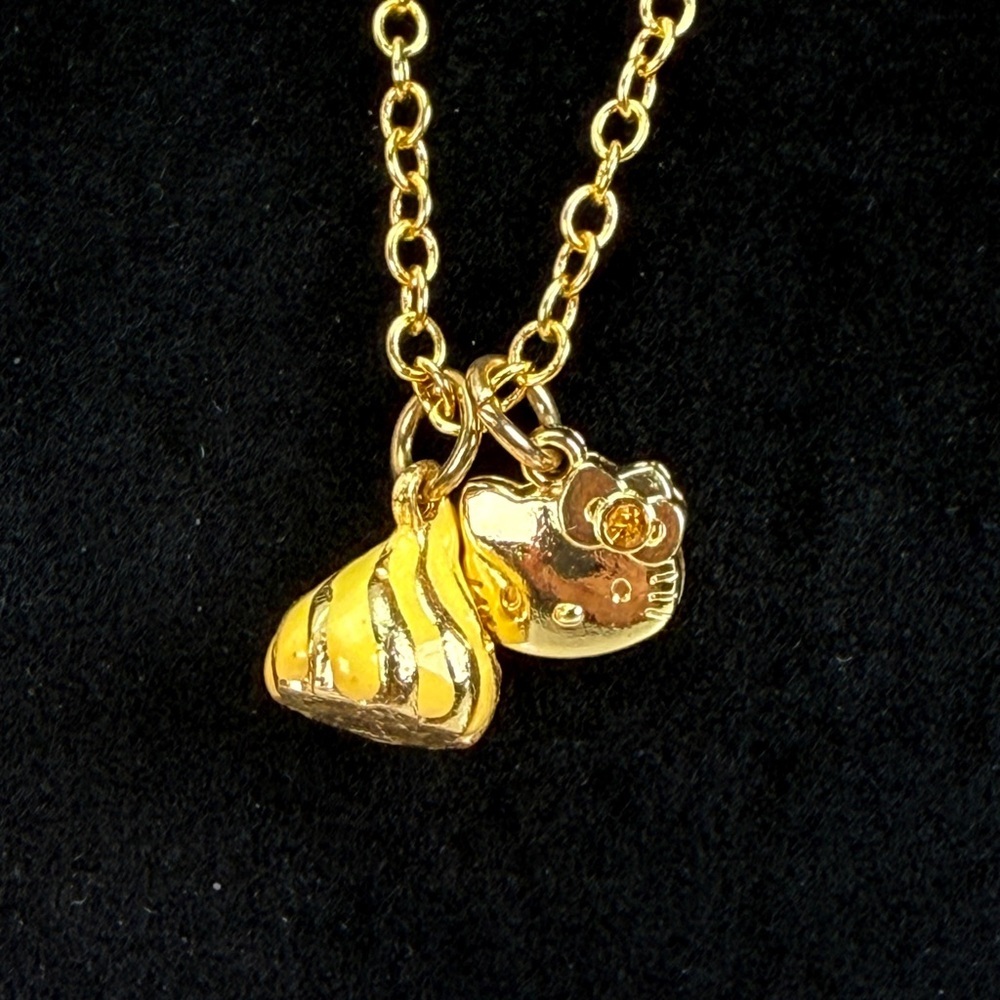 Vintage goldtone chain with Hello Kitty and Hershey’s kiss charms necklace.
